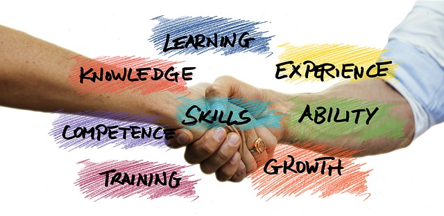 Handshake with words over: learning, experience, ability, growth, training, competence, knowledge, skills