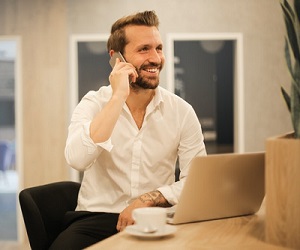 man smiling and talking on mobile phone